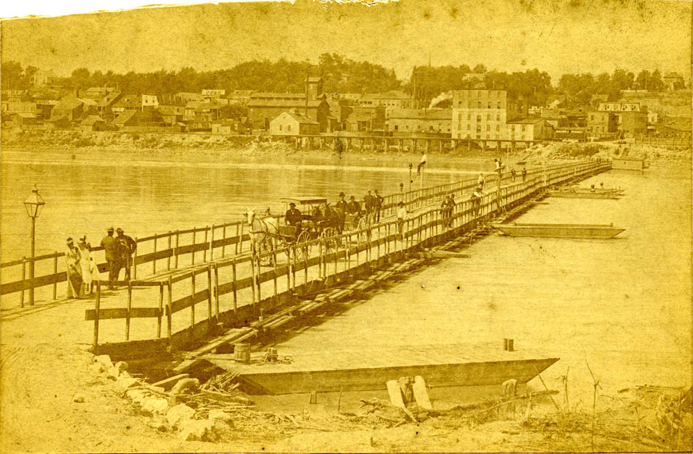 People crossing a pontoon bridge.