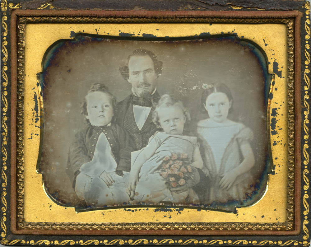 Charles Clark sitting with his three granddaughters.