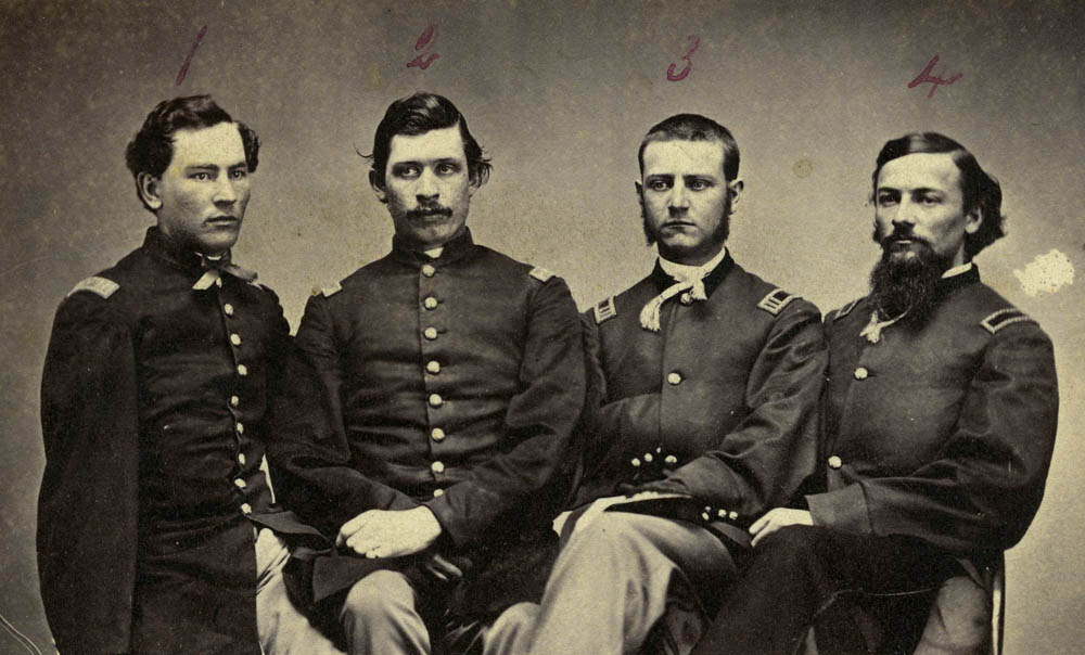 Photograph of Barnaabay D. Palmer, A. Dutcher, T. Mower McDougall, and Howard Williams all seated in their uniforms.