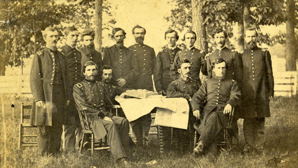 Grenville Dodge sitting around a table with staff.