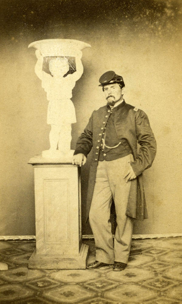 William Eisermann in uniform next to statue.