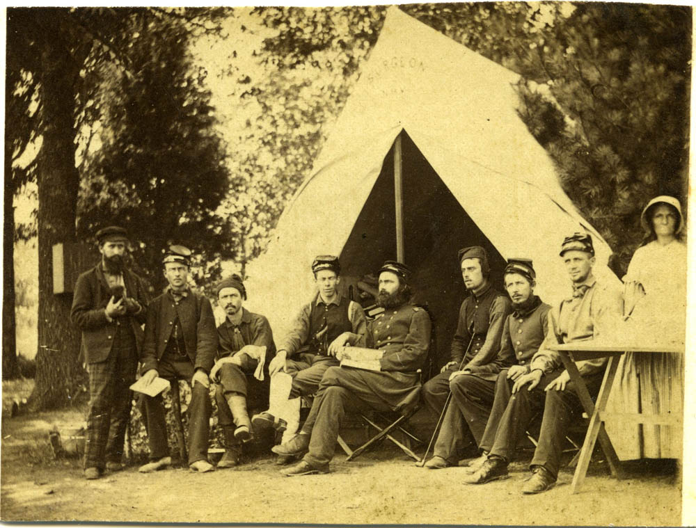 George Hubbard sitting in uniform with staff.