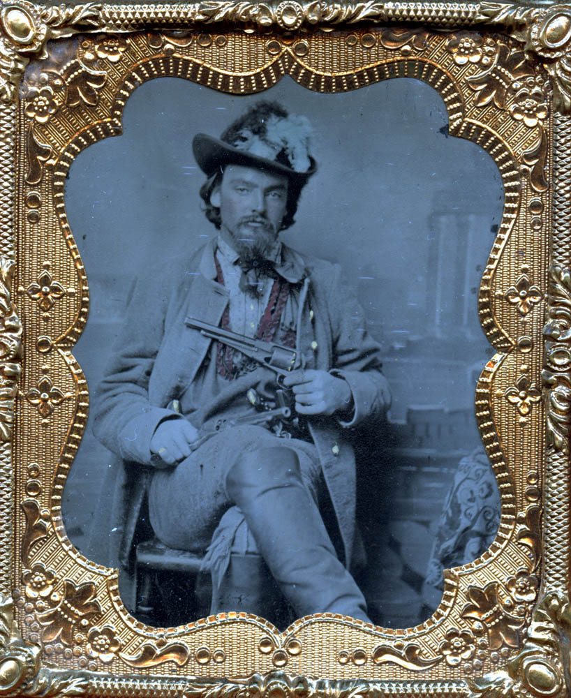 Ambrotype of George Maddox seated holding a gun.