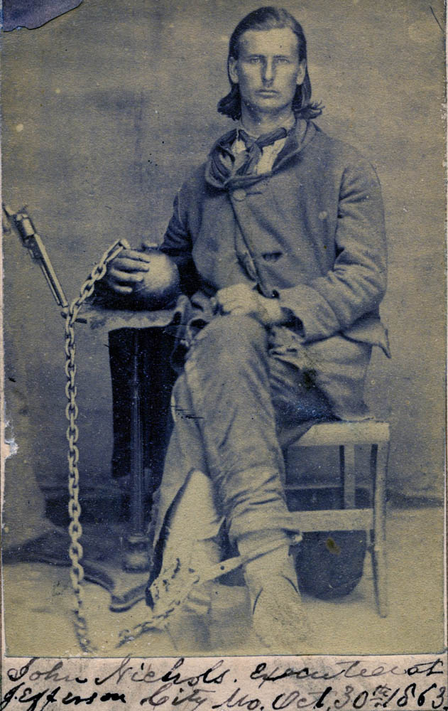 Photograph of John Nichols, in cast ironchains.