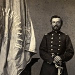 Charles Zagonyi leaning on sword next to a pedestal with a Springfield, Mo. flag.