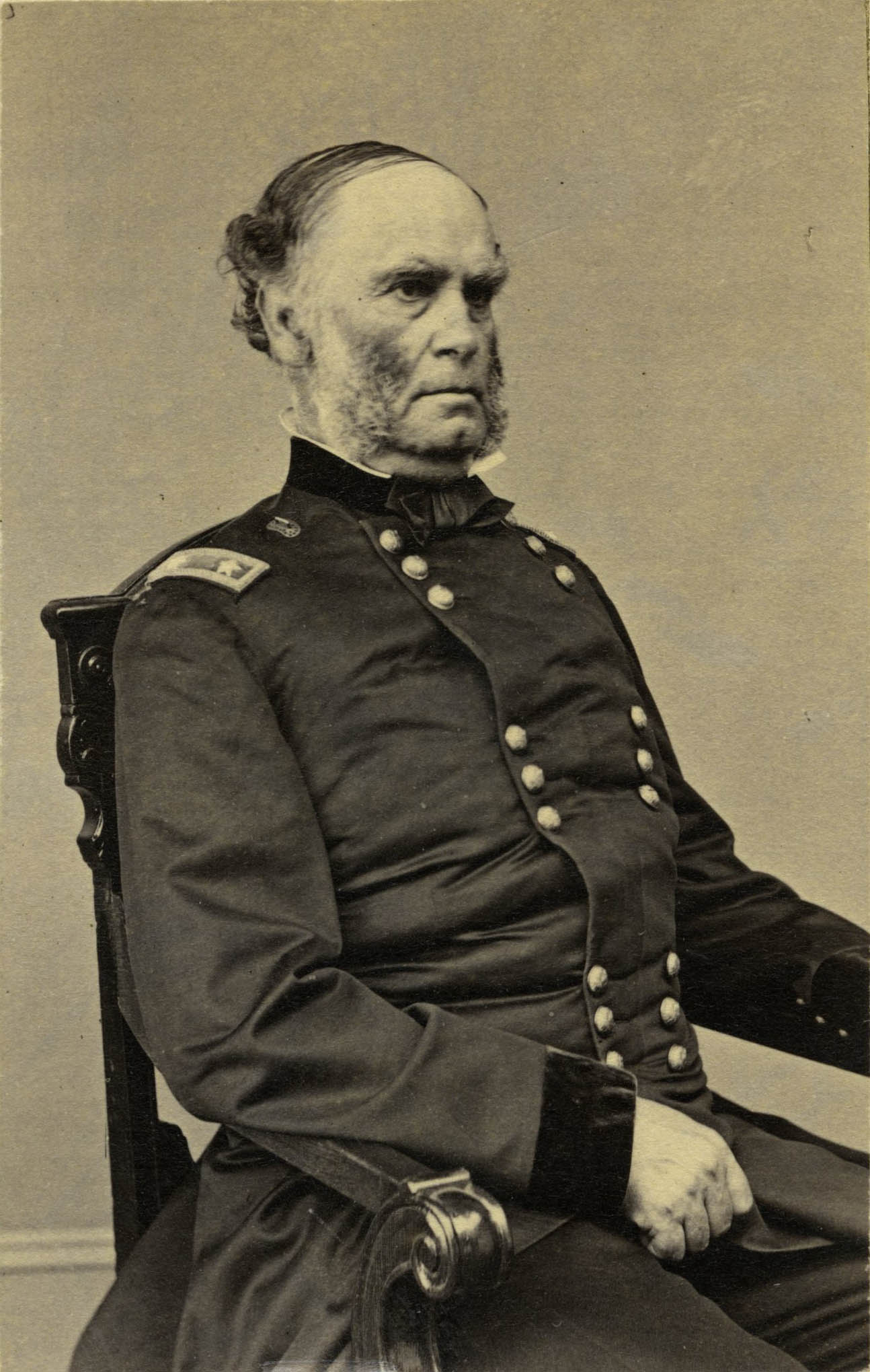 Samuel R. Curtis sitting in uniform. View from side.