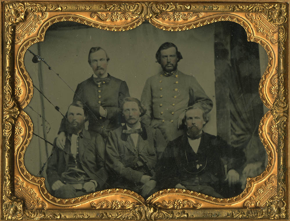 Cased photograph of five men, two standing three sitting.  