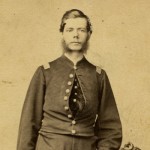 Herman Huiskamp standing in uniform next to chair.